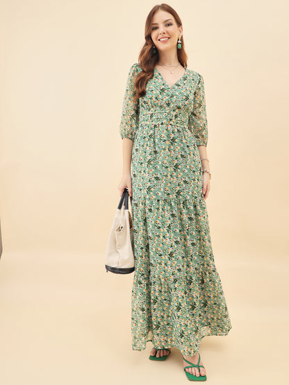 Woman wearing a green floral dress against a beige background