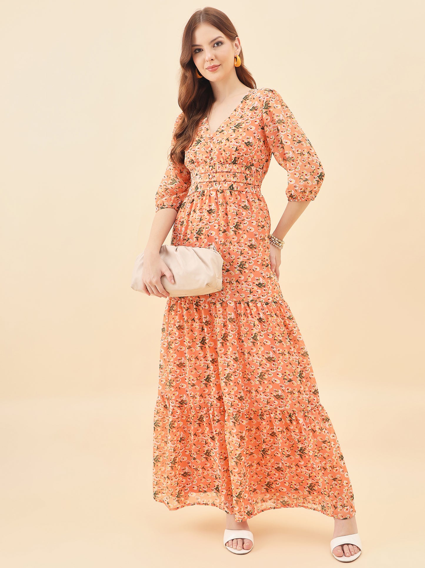 Woman wearing an orange floral dress on a beige background