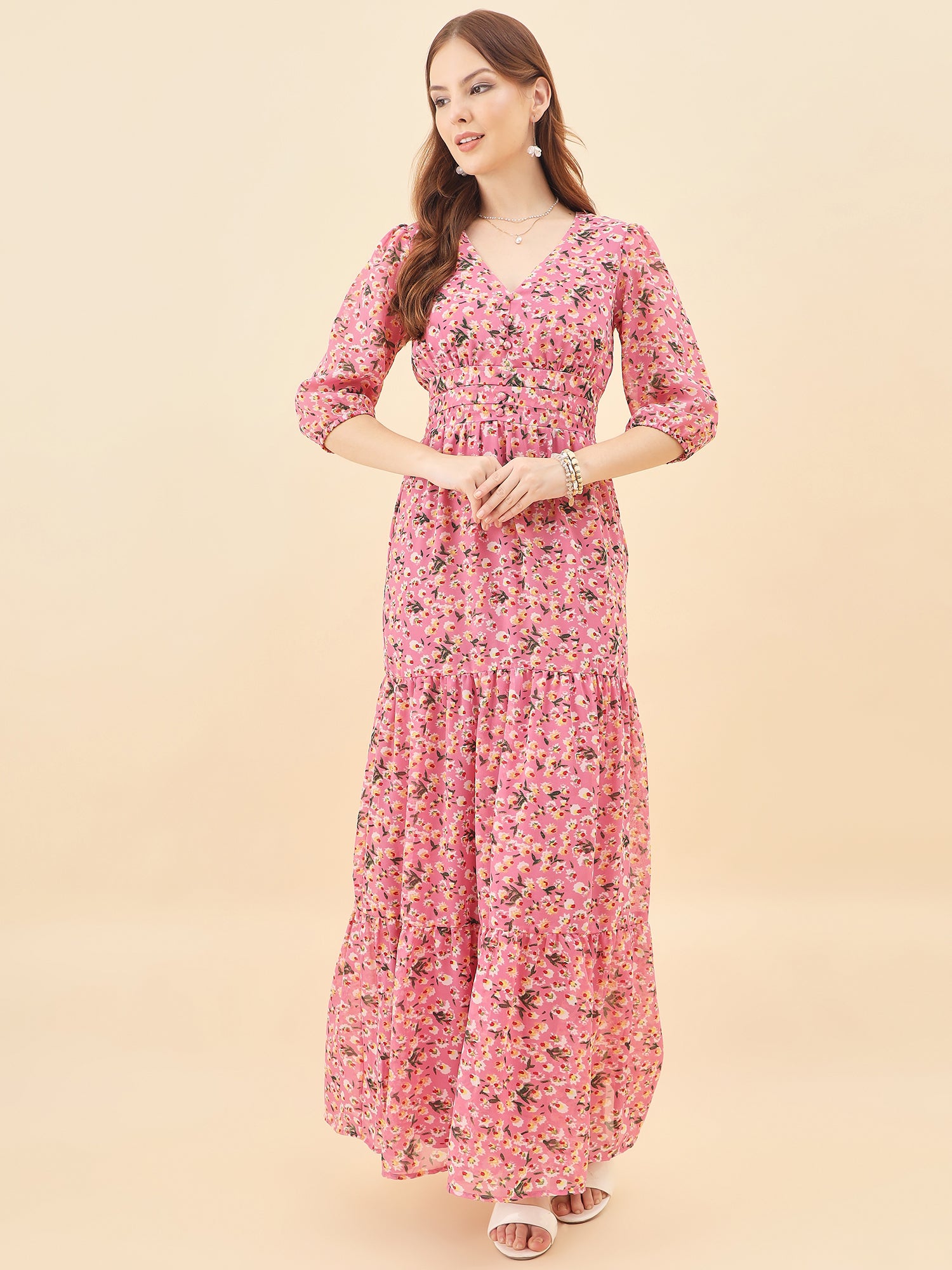 Woman wearing a pink floral dress on a beige background
