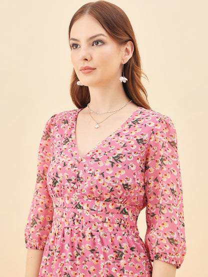 Woman wearing a pink floral dress against a beige background