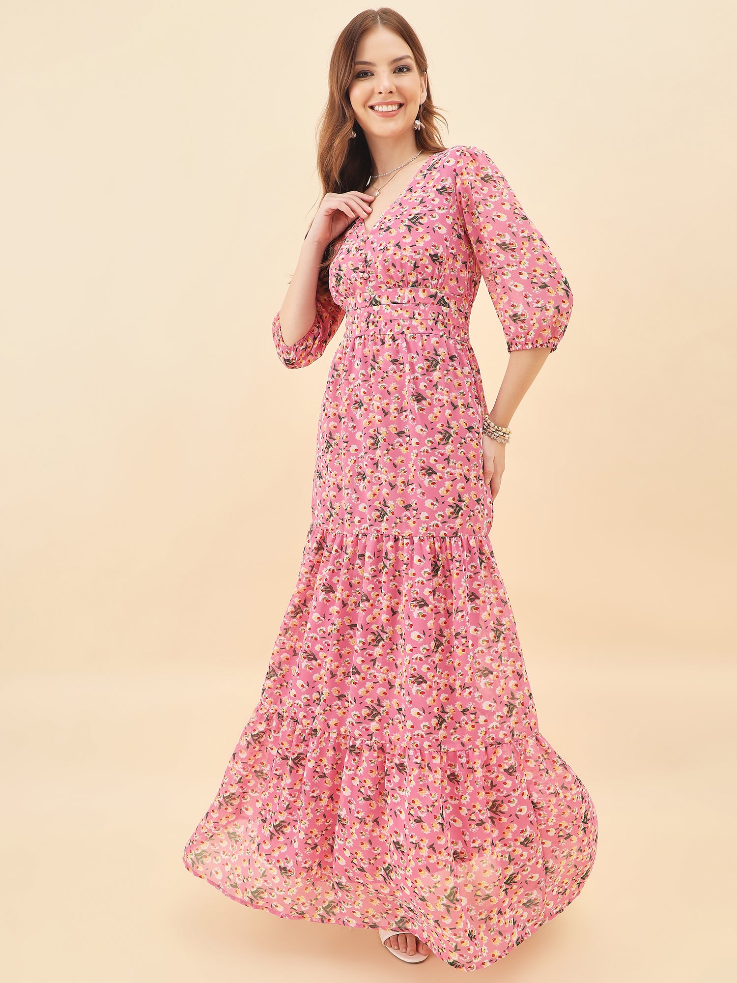 Woman wearing a pink floral dress against a beige background