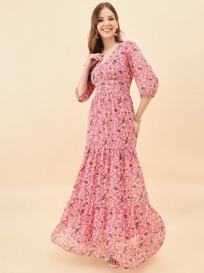 Woman wearing a pink floral dress against a beige background