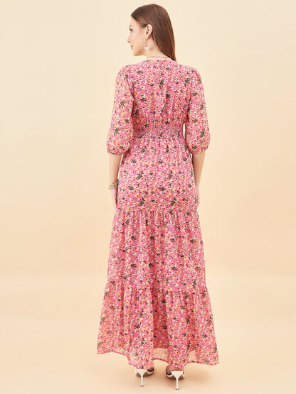 Woman wearing a pink floral dress against a beige background