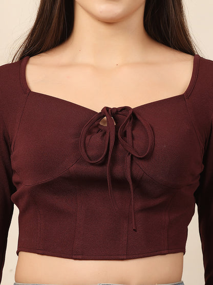 Wine crop top with a tie detail on a neutral background