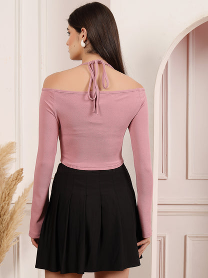 Woman wearing a Mauve off-shoulder top and black skirt in a neutral setting