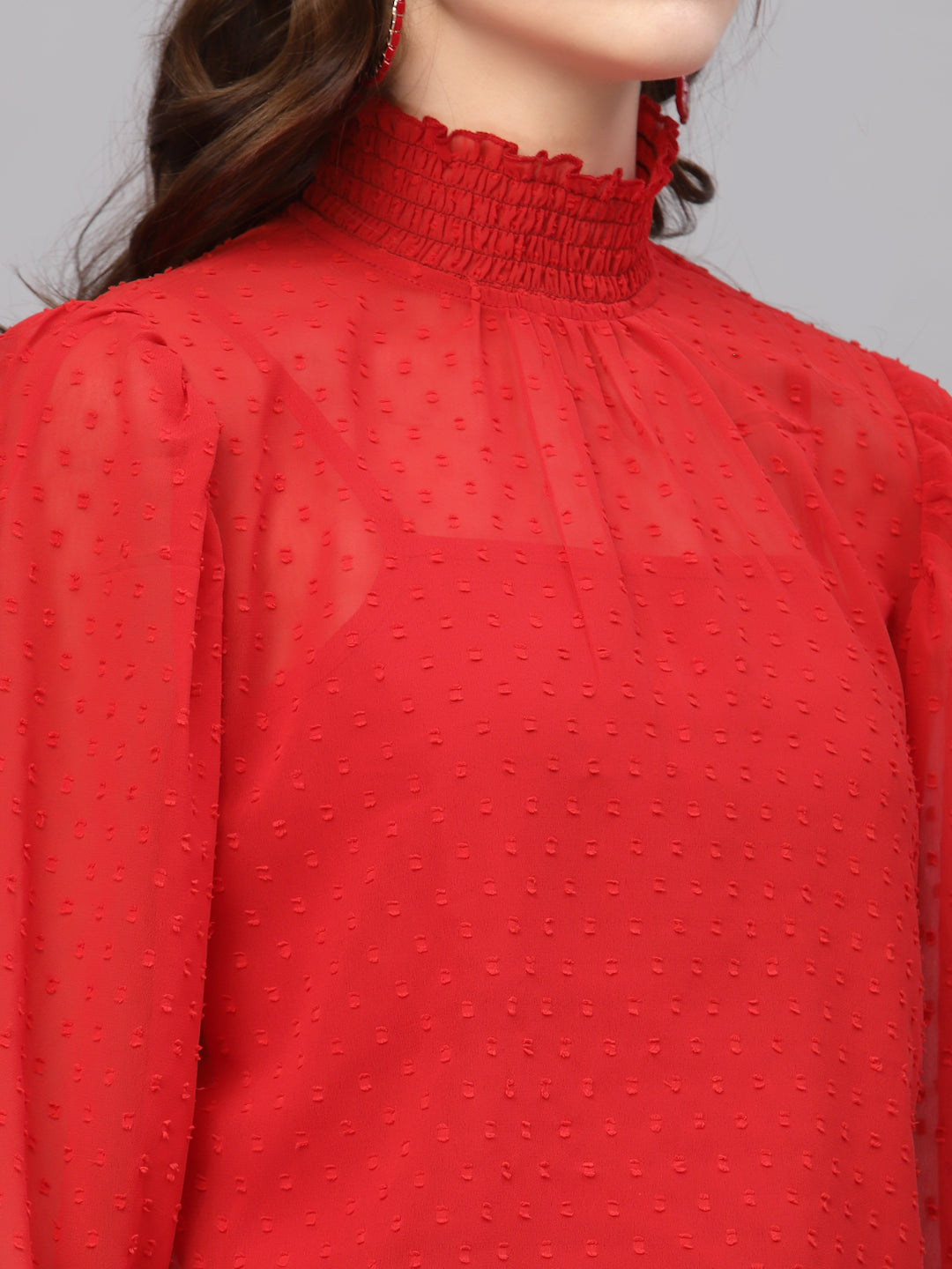 Red top with a textured pattern on a plain background