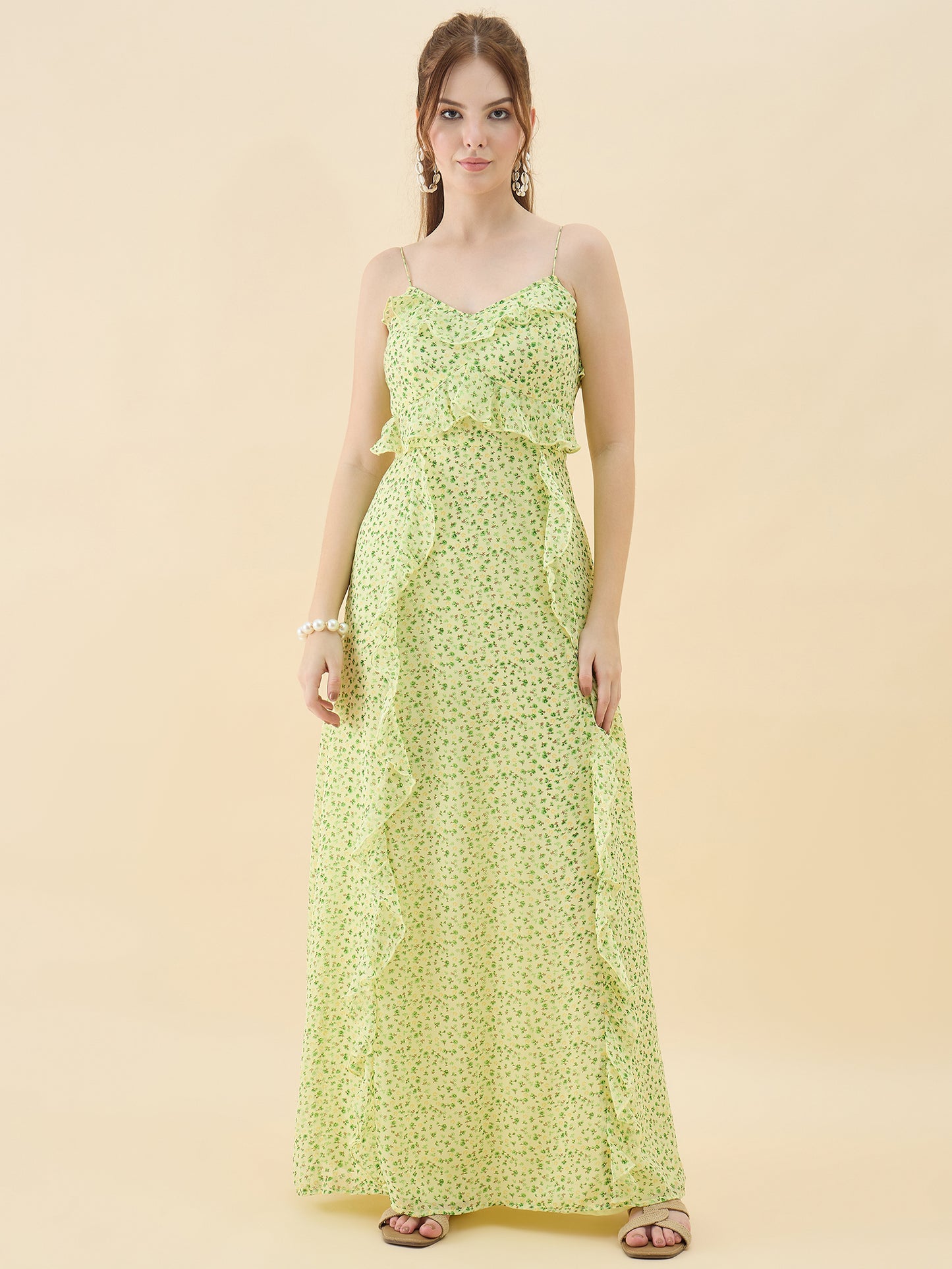 Woman wearing a light green floral dress against a beige background
