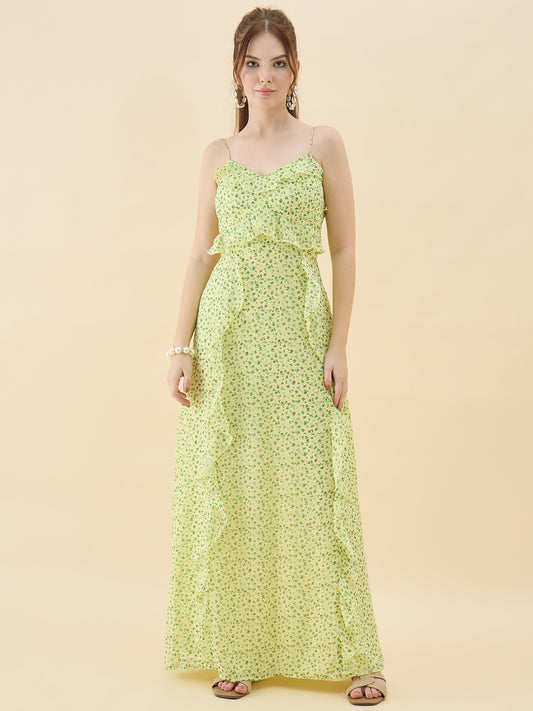Woman wearing a light green floral dress against a beige background
