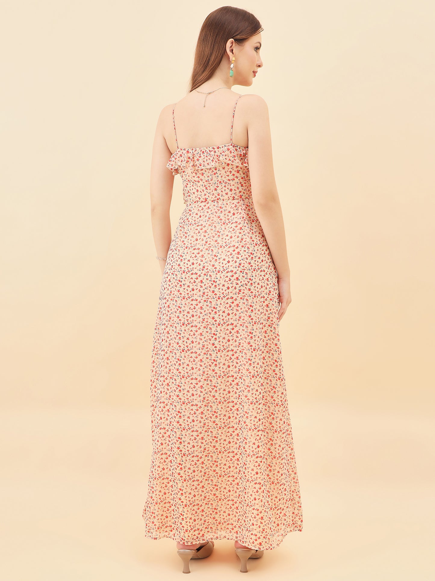Woman wearing a floral dress against a beige background