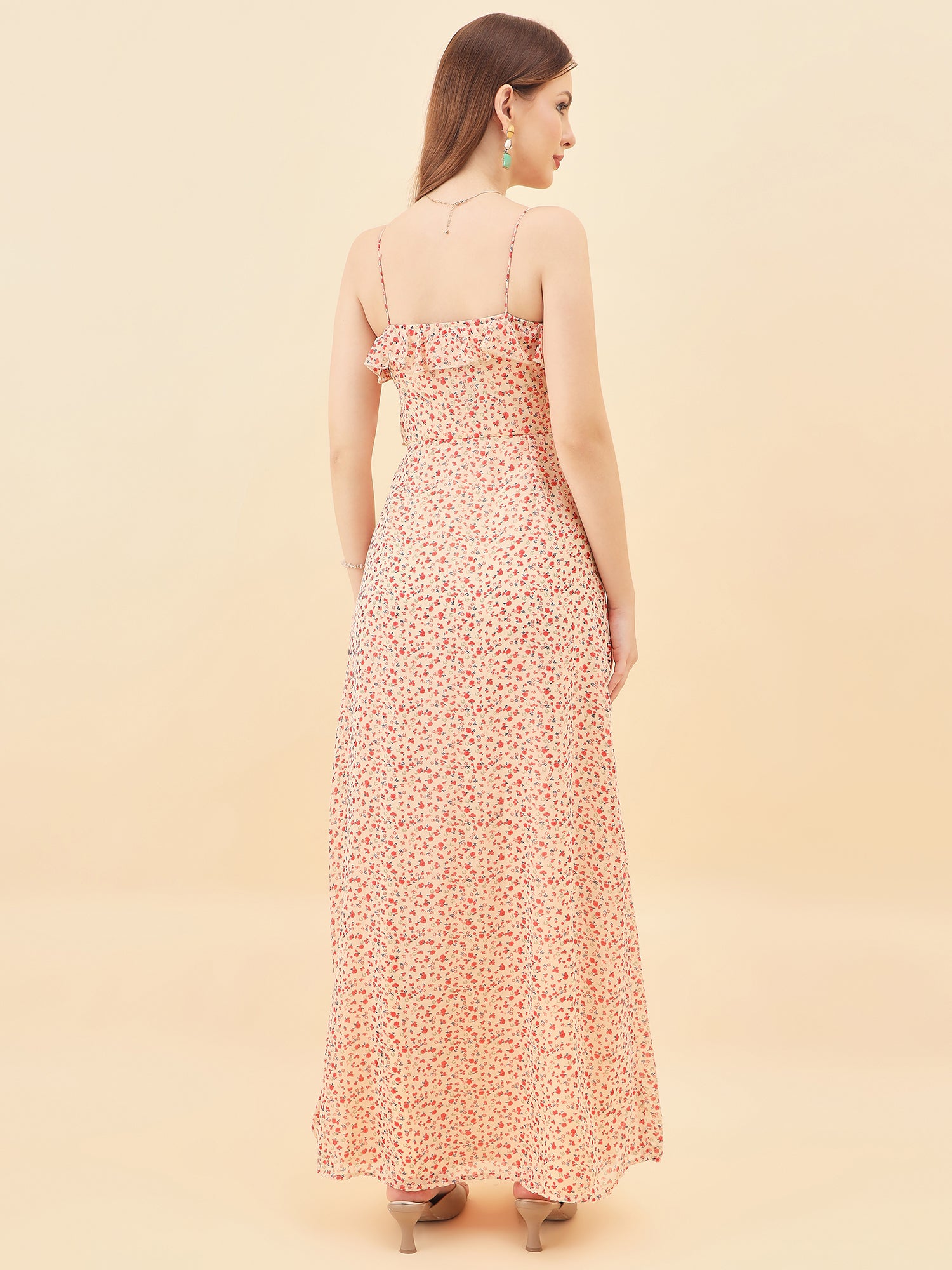 Woman wearing a floral dress against a beige background