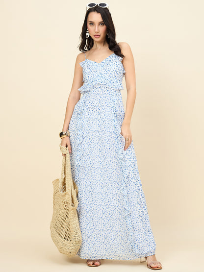 Woman wearing a blue floral dress holding a beige bag on a beige background