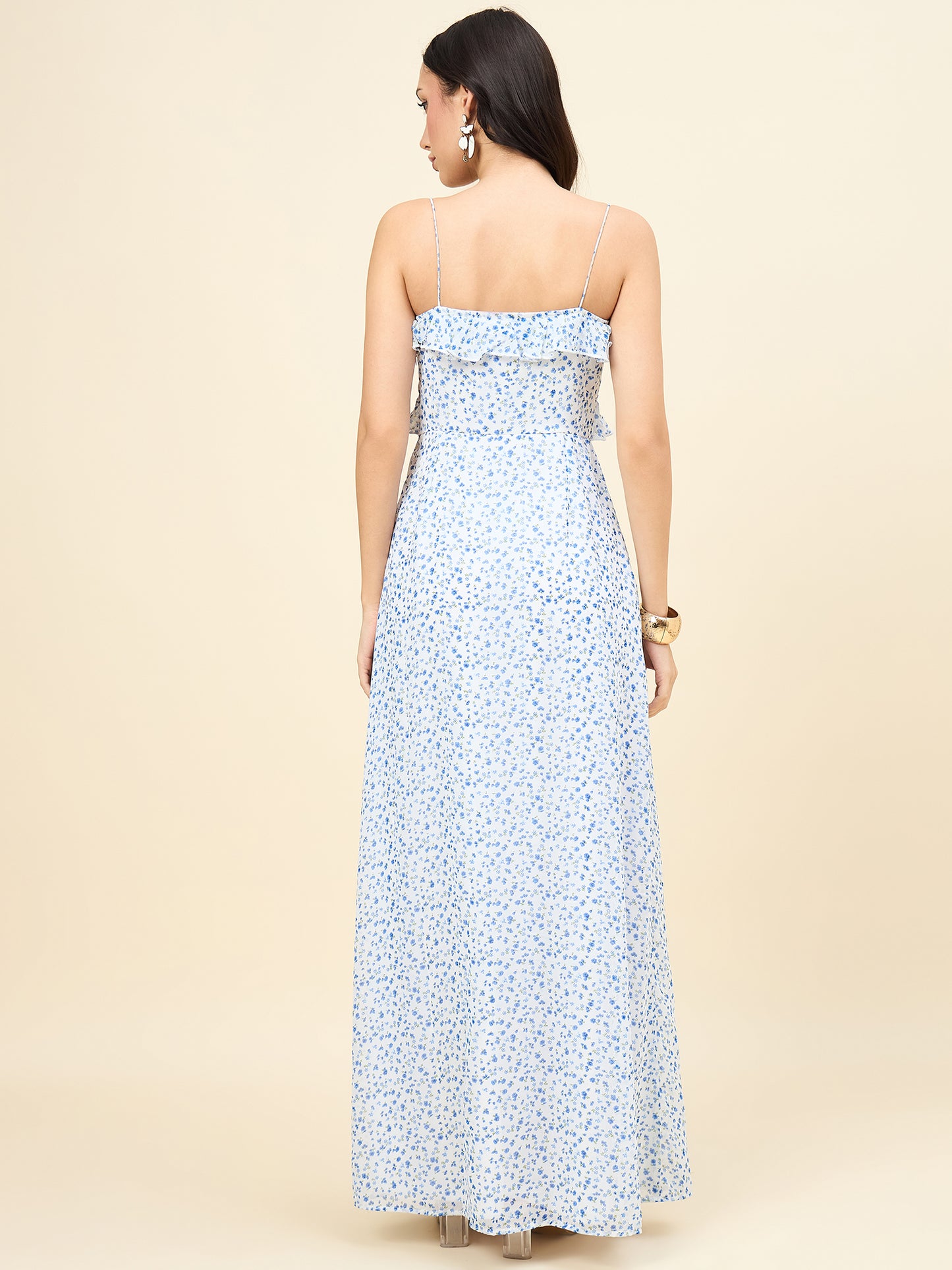 Woman wearing a strapless floral dress on a beige background