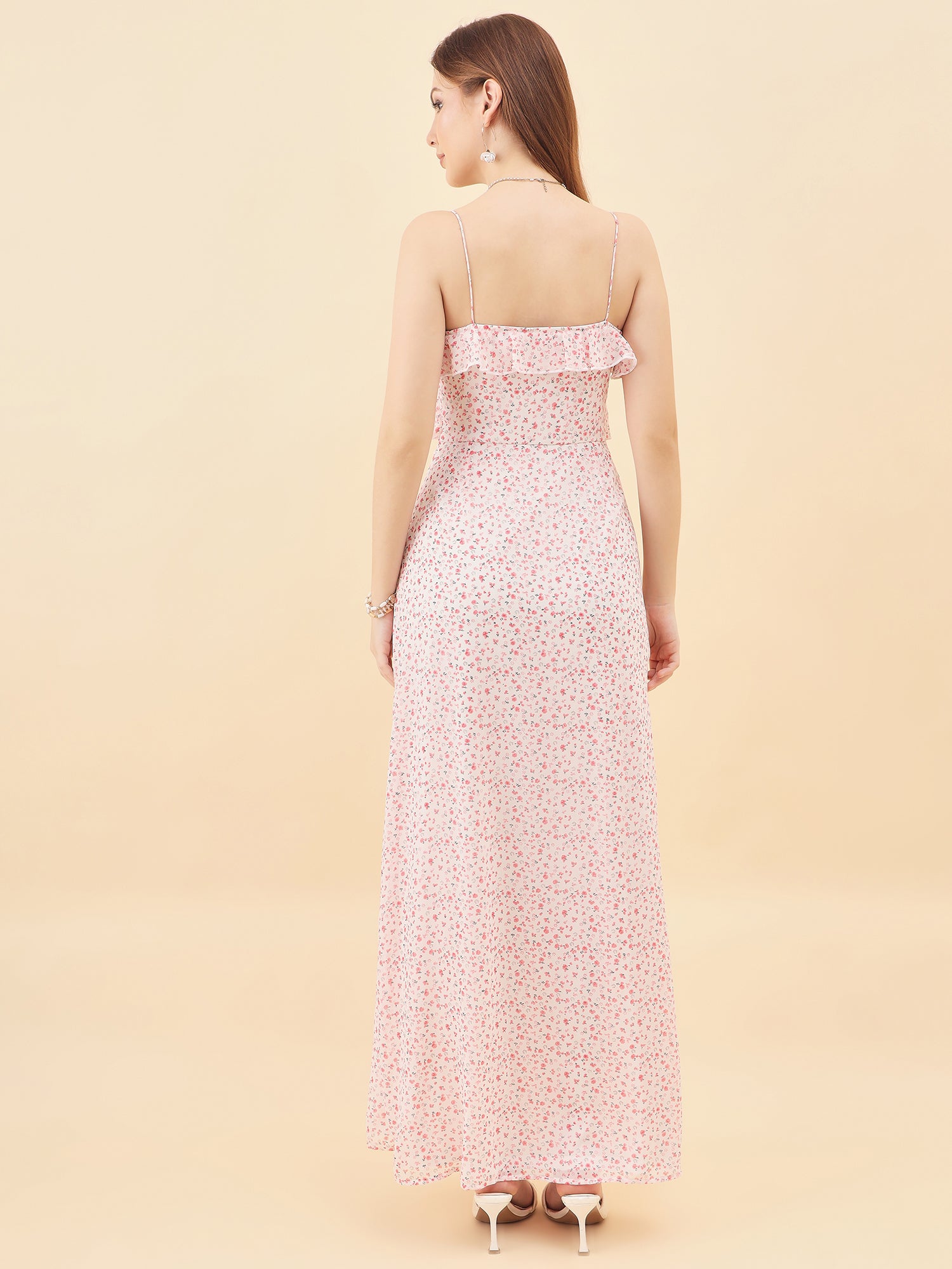 Woman wearing a floral strapless dress against a beige background