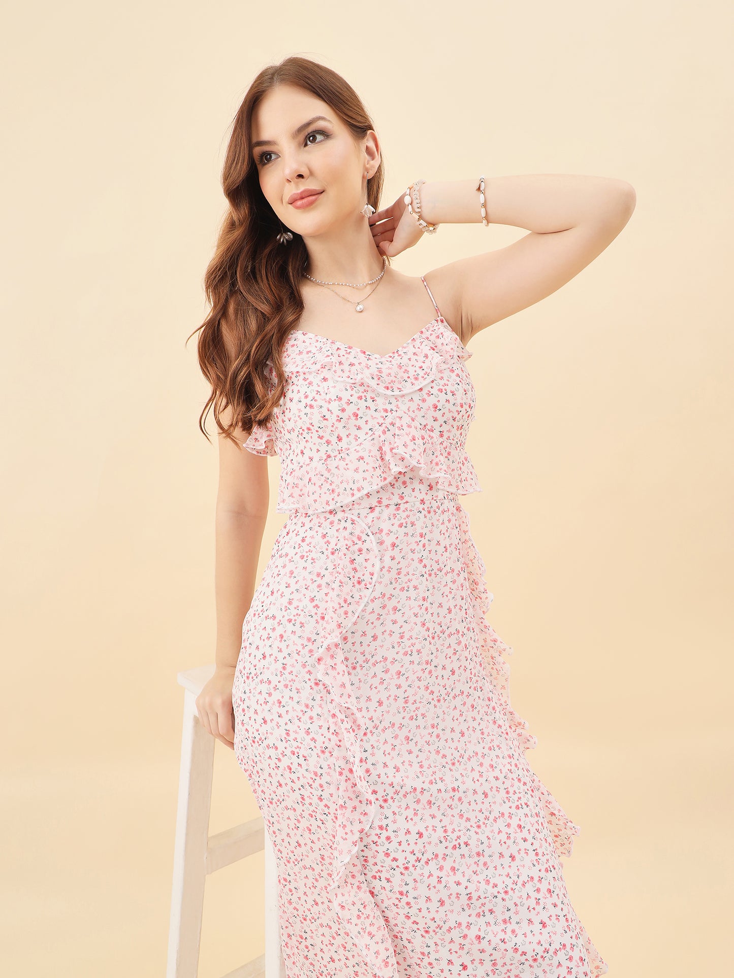 Woman wearing a floral dress against a beige background