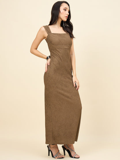 Woman wearing a brown sleeveless dress against a beige background