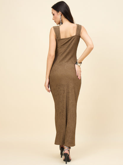 Woman wearing a brown dress with a plain background