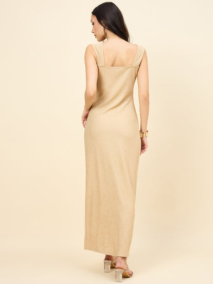 Woman wearing a beige evening gown against a plain background