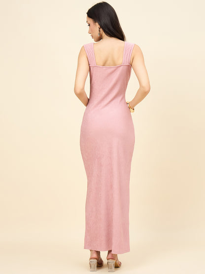 Woman wearing a pink dress against a beige background