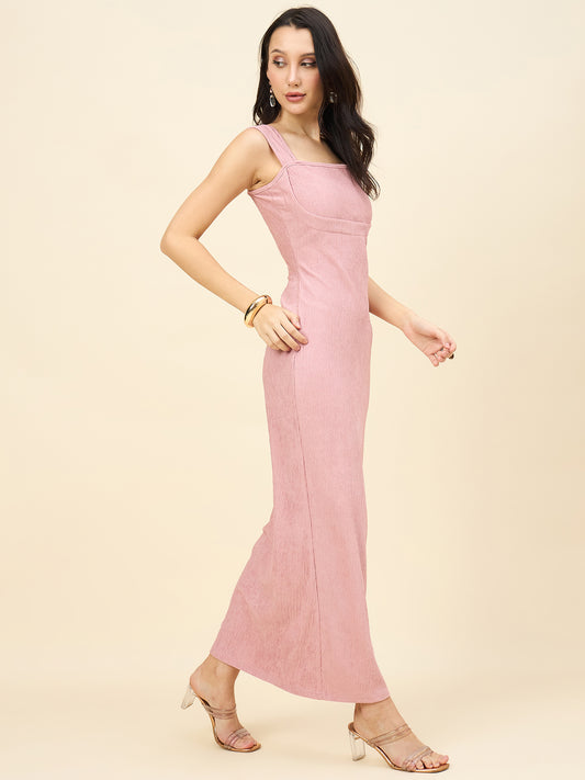 Woman wearing a pink dress against a beige background