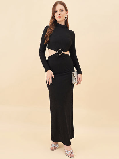 Woman wearing a black long-sleeve top and black skirt with a belt on a beige background