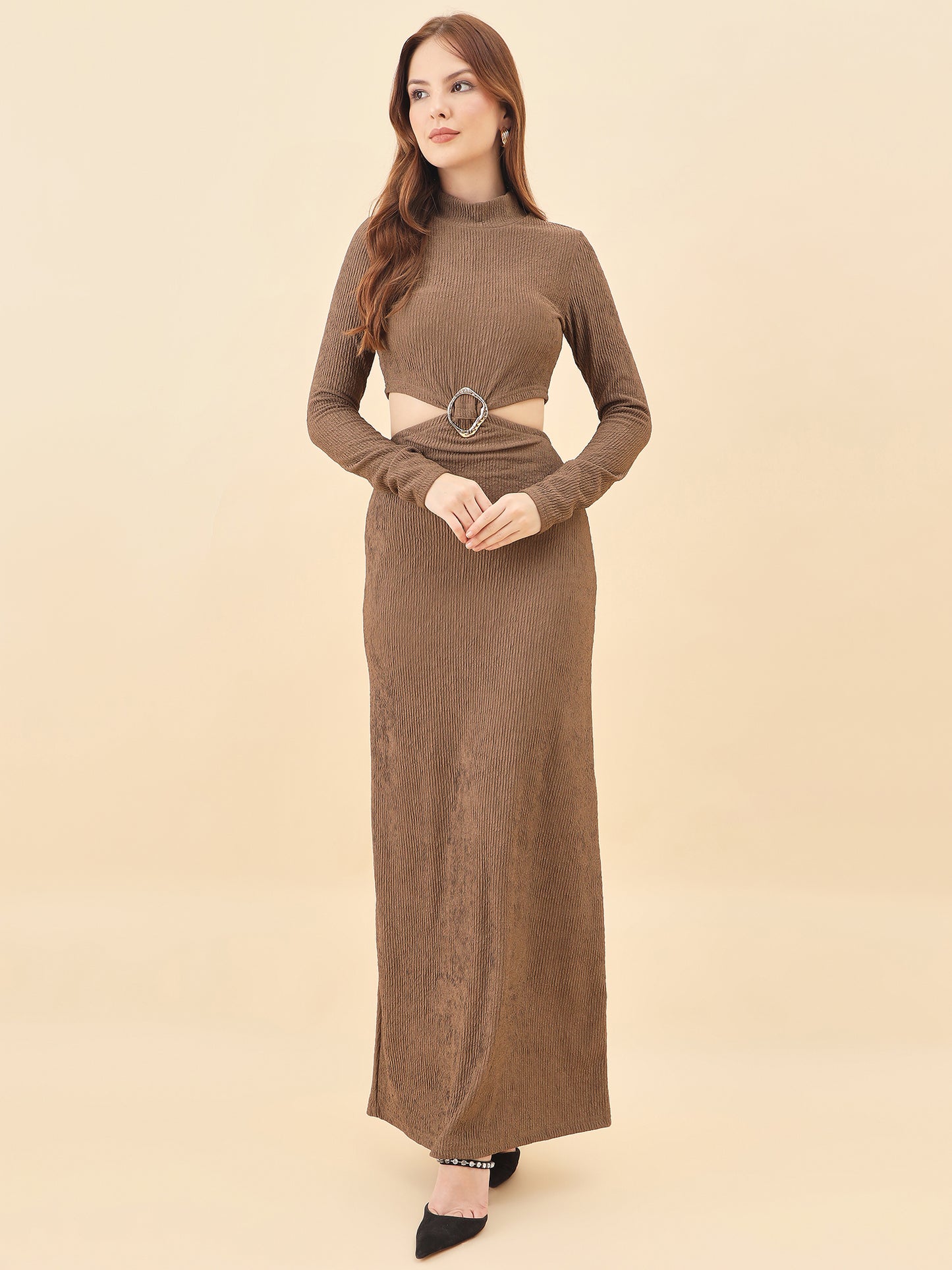 Woman wearing a brown long-sleeve dress with a belt on a beige background
