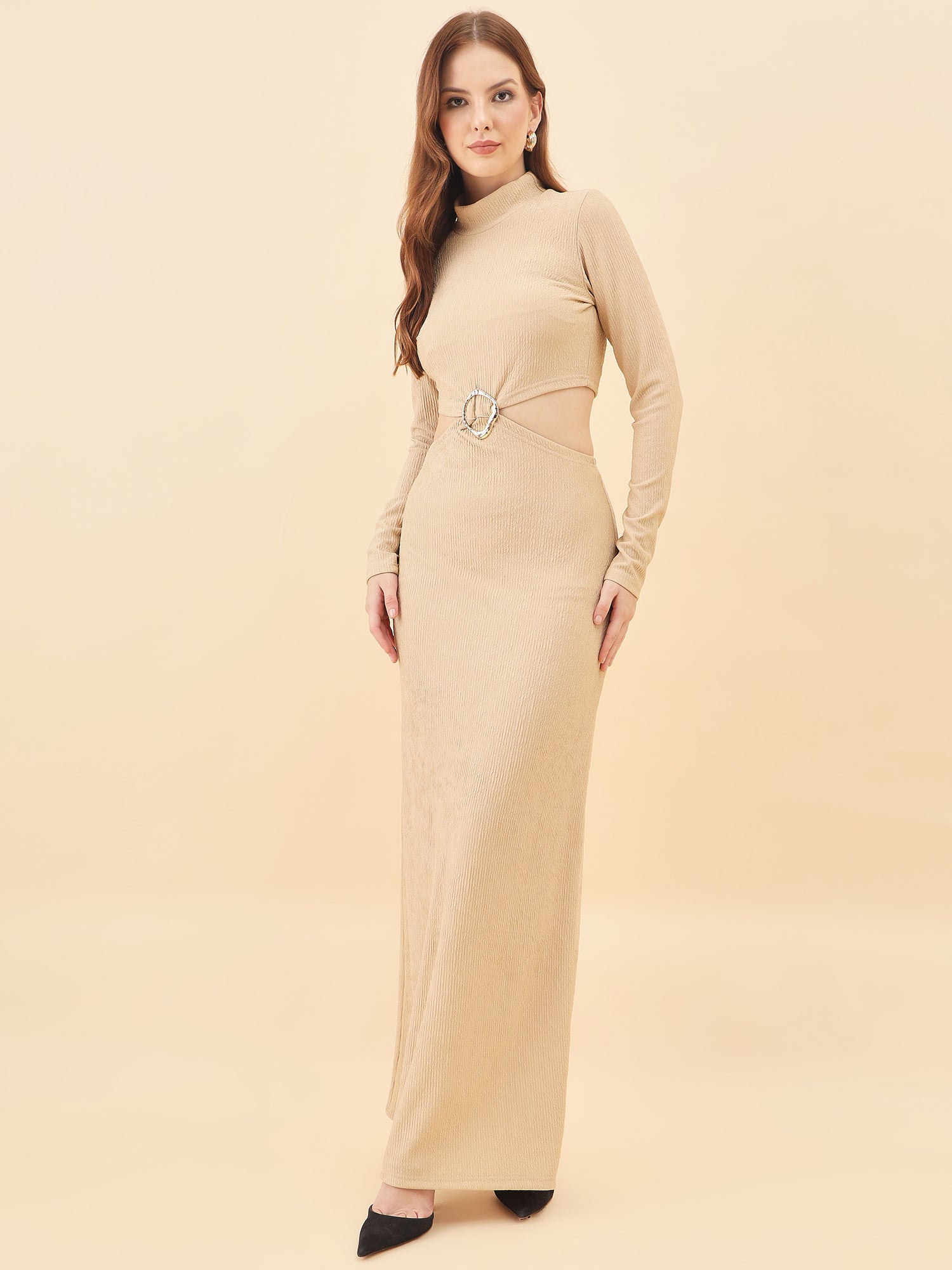 Woman wearing a beige long-sleeve dress with a belt on a beige background