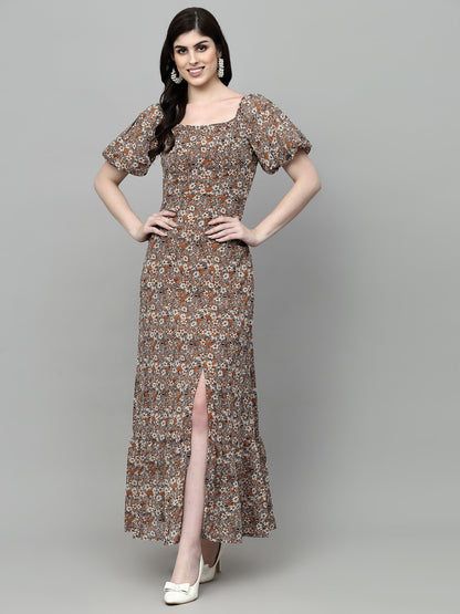 A woman standing and posing in a fit and flare multicolor dress with a floral pattern.