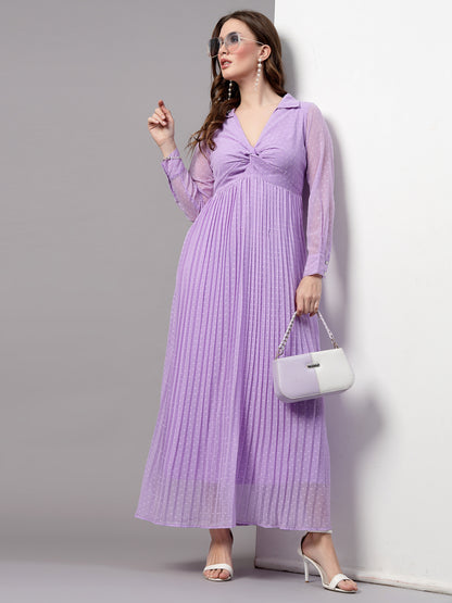 A woman wearing a fit and flare lavender dress with long sleeves and a V-neckline.