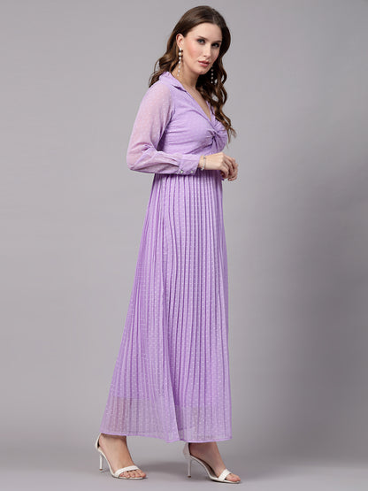 A woman wearing a fit and flare lavender dress with long sleeves and a V-neckline.