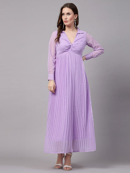A woman wearing a fit and flare lavender dress with long sleeves and a V-neckline.