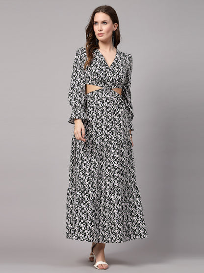 A woman standing and modeling a black and white fit and flare dress with a V-neckline and sleeveless design.