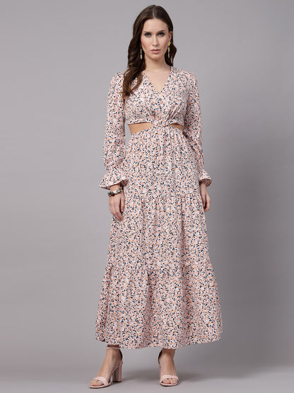 A woman standing and modeling a floral fit & flare peach-colored dress with short sleeves and a V-neckline.