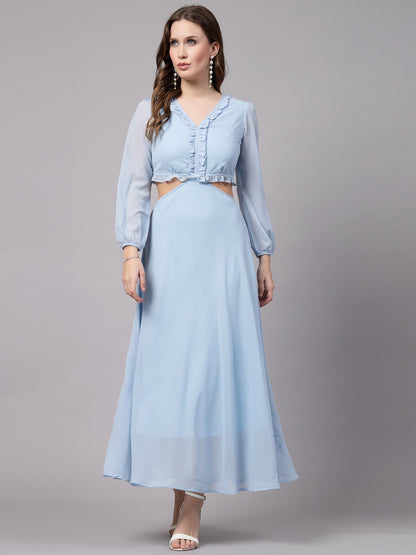 A woman wearing a sky blue, fit and flare dress with floral embroidery on the top and bottom, paired with white sandals.