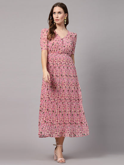 A woman wearing a fit and flare pink dress with short sleeves and a round neckline.