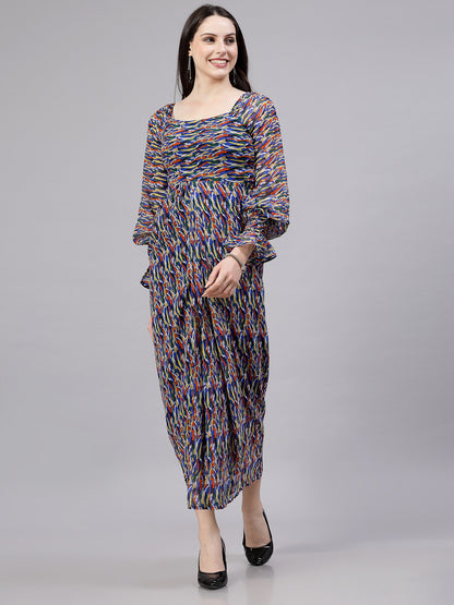 A woman standing and smiling, wearing a multicolored printed maxi dress with a round neckline and three-quarter sleeves.