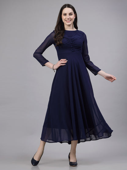 A woman wearing a fit and flare blue solid dress with 3/4 sleeves and a round neckline.